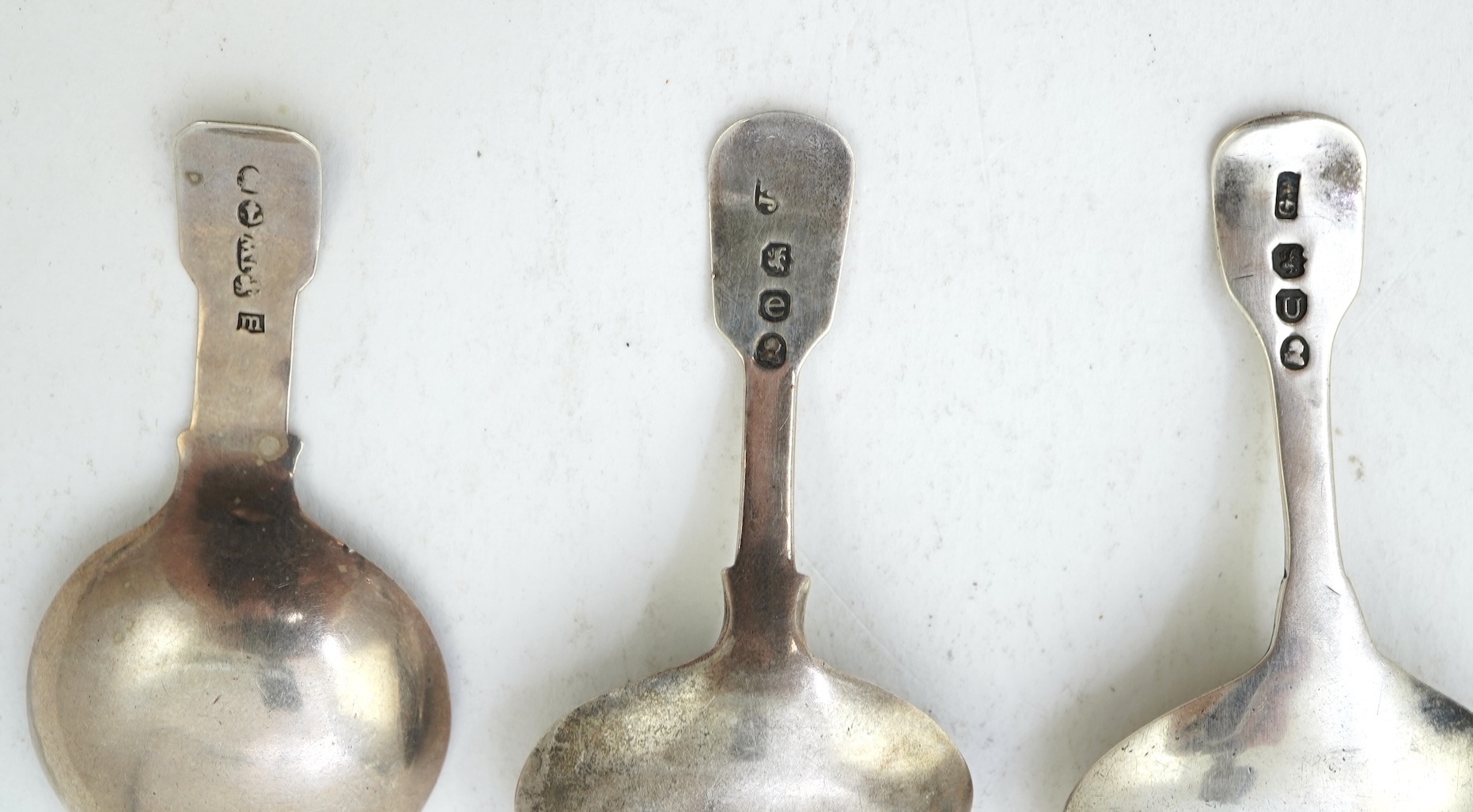 A collection of ten assorted mainly 19th century silver and white metal fiddle pattern caddy spoons